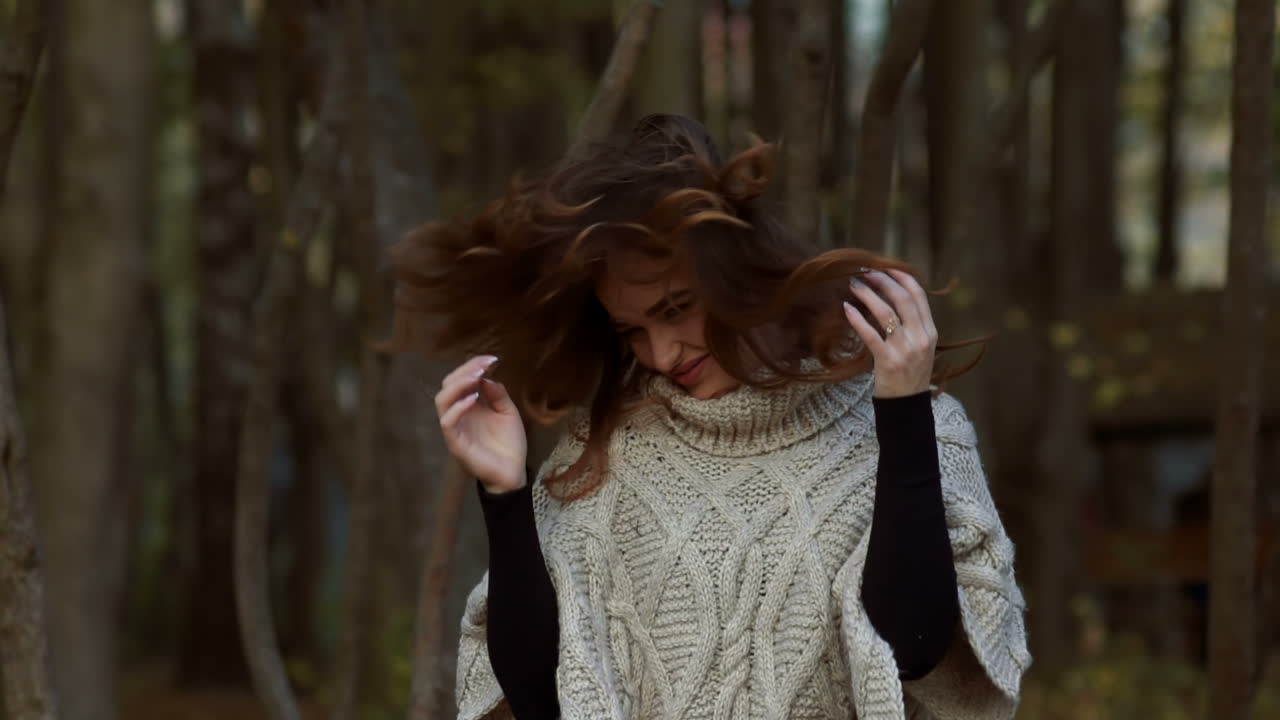 Girl walking in park. Attractive woman walking in autumn forest