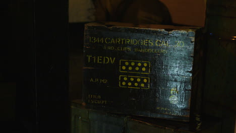 A-pan-across-an-old-style-military-ammunition-box,-or-ammo-box