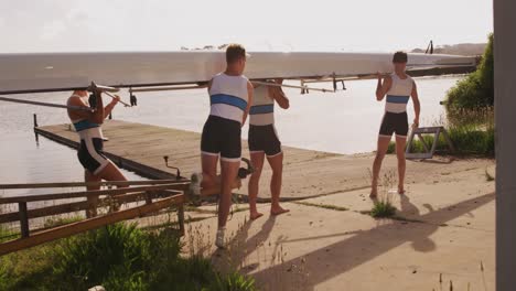 male rower team carrying the boat on their shoulders