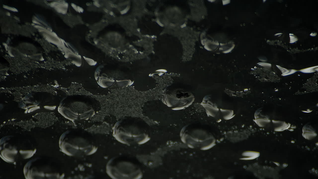 Dark cinematic close-up of water dripping from a leaking ceiling, with moody lighting, murky shadows, and atmospheric texture that evokes mystery, decay, suspense, and haunting urban beauty
