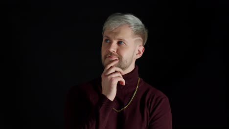 Thinking-man-looking-up-and-around-contemplating-how-to-solve-problem-against-black-background