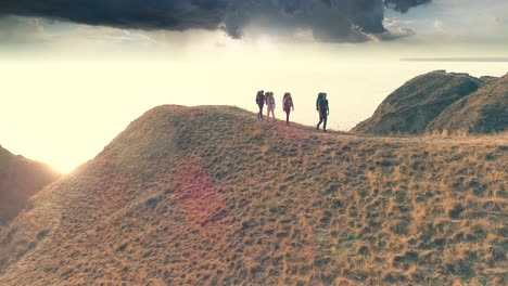 the four travelers walking on the mountain range on the beautiful sea background