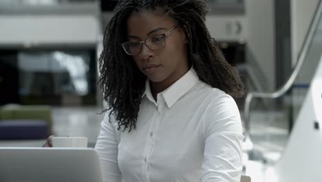 focused young businesswoman working during coffee break