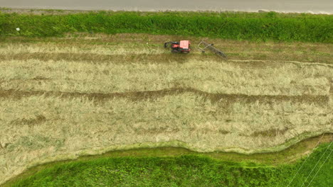 aerial view of a tractor working in a freshly cut field