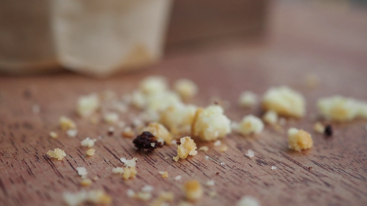 Macro Shot of Sweet Cake Crumbs on a Wooden Surface