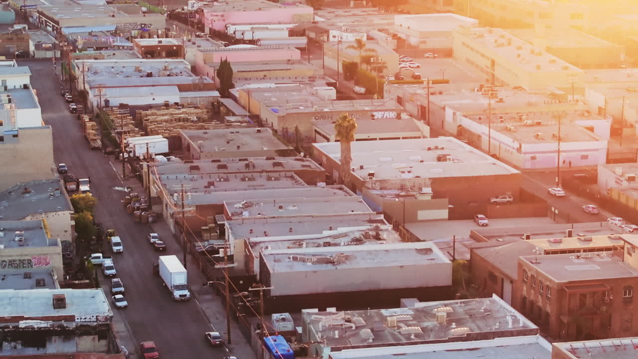 Aerial view of an urban area with buildings and a street during golden hour