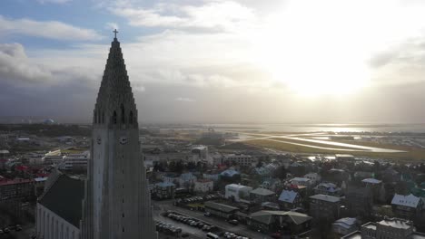 static drone shot at church of hallgrímur in capital city of iceland with sunrise