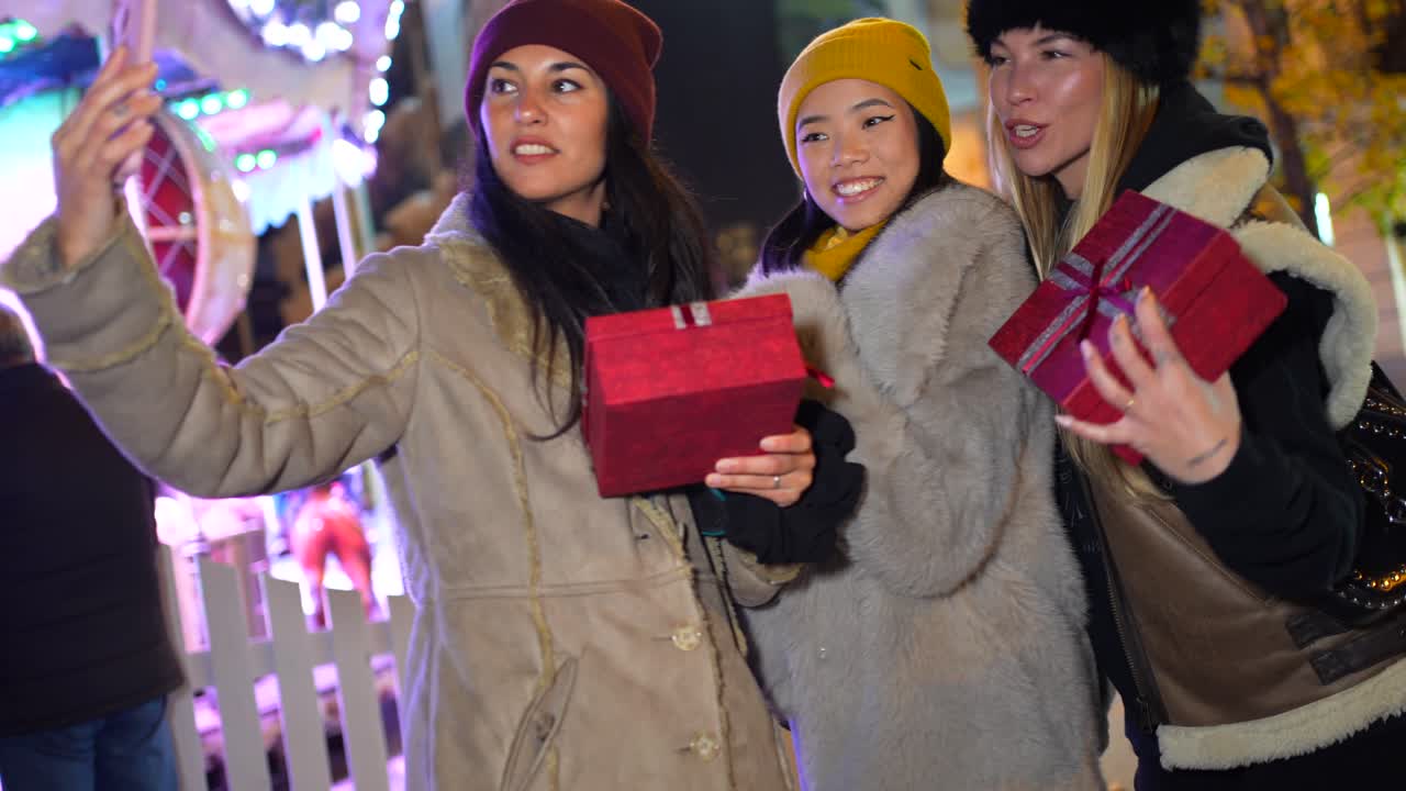 Friends celebrating winter holidays with gifts and taking selfies
