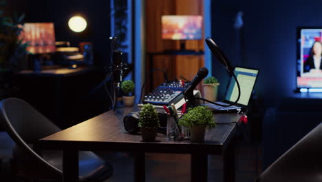 Empty-desk-in-home-production-studio-with-podcast-equipment-technology