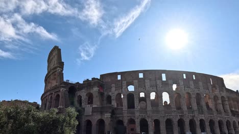 tourists visiting the ancient colosseum under a bright sun