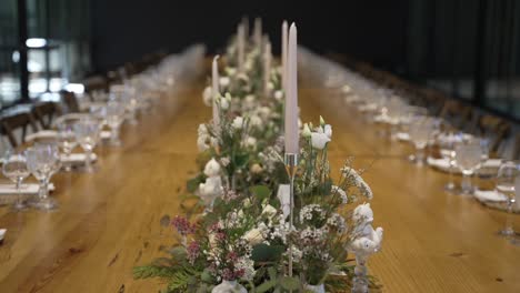 elegant dining table setup with floral centerpieces and candles for a formal event