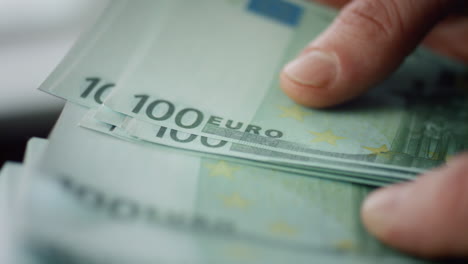 closeup hands counting money cash. cashier man holding bills european currency.