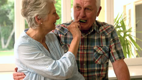 cute mature couple feeding each other