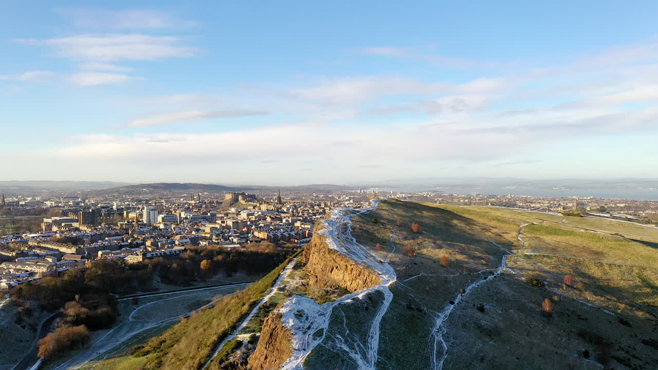 Aerial shot of Edinburgh's Arthur Seat covered in snow on a beautiful winter day