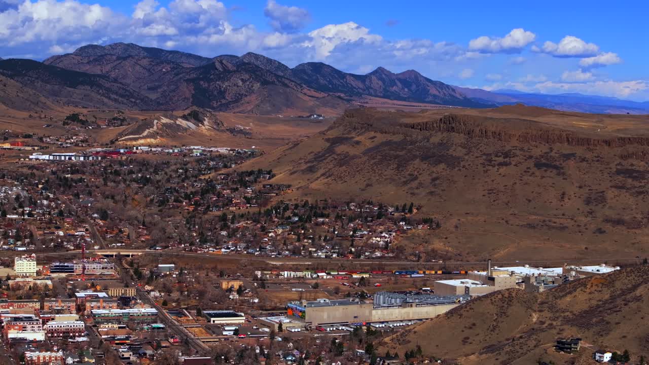 Beautiful crisp cold winter day sunny clouds downtown historic Golden Colorado aerial drone North Table Mountain Flat Irons Boulder highway 93 Golden Gate Canyon Coors Beer Factory down jib motion
