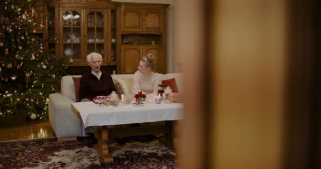 grandfather talking with granddaughter at home 1