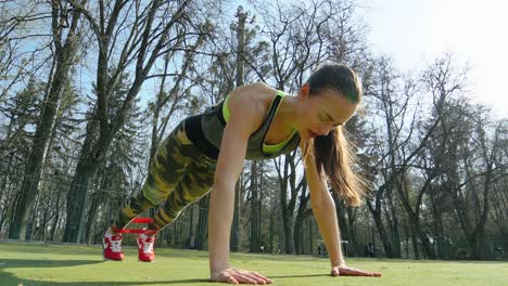 Young sporty woman runner with elastic bands outside at the stadium. Beautiful girl doing exercises. Healthy sports lifestyle