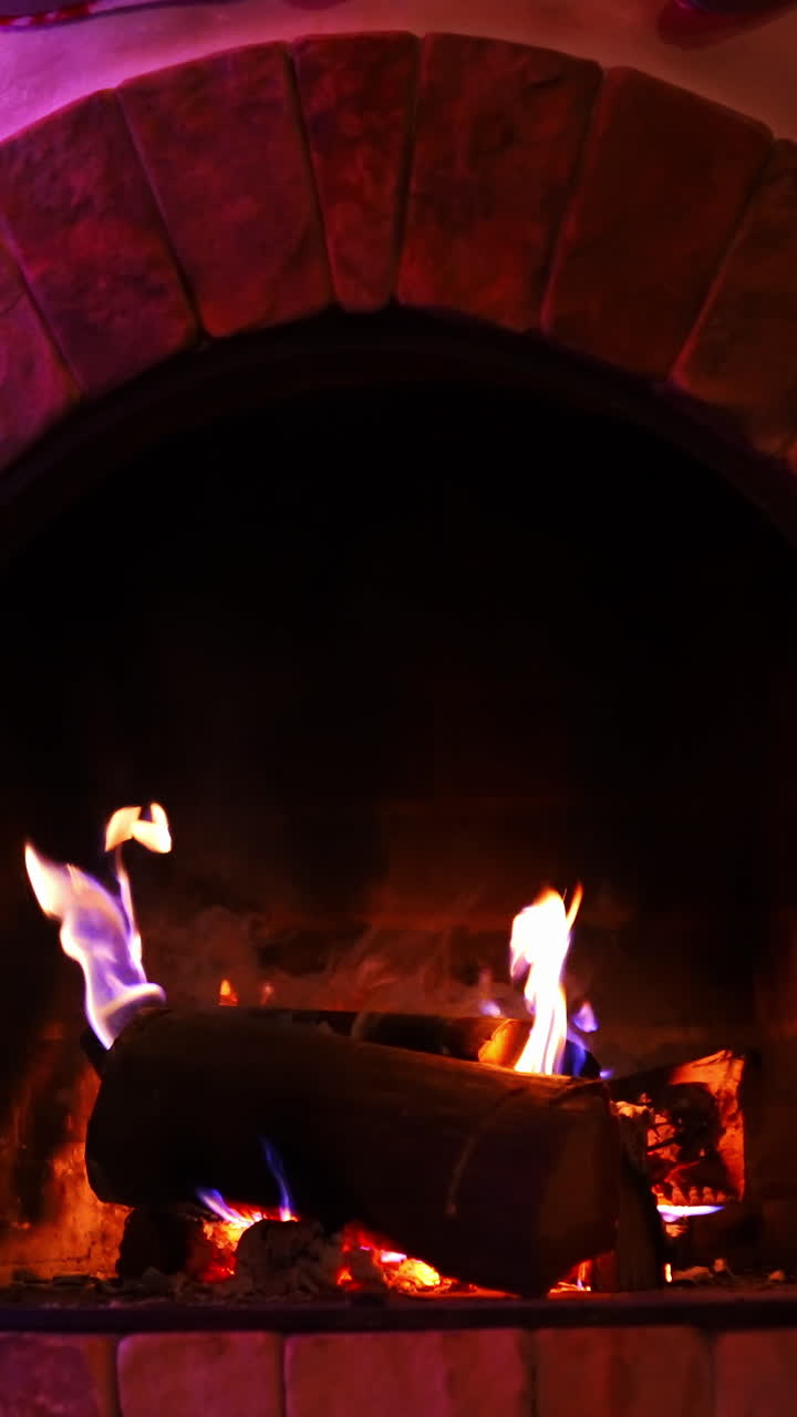 Fireplace With Roaring Flames. Fireplace in empty living room interior of house. Vertical video