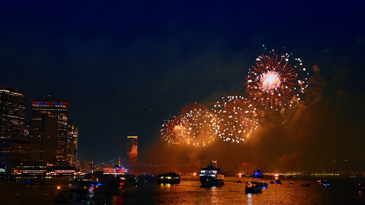 Amazing fireworks flashing in the dark sky over the East River. 4th July celebration in New York, USA. View from the waterscape
