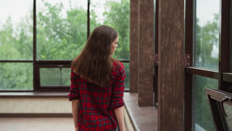 lady strolls arching neck back by windows woman finds solace within expansive studio adorned