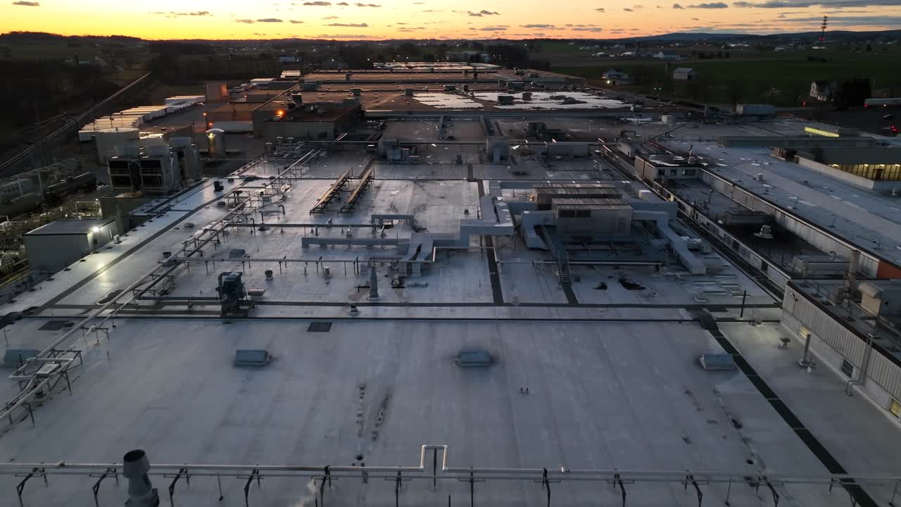 Sunset over factory and warehouse in America