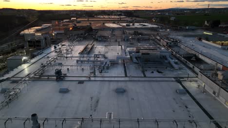 sunset over factory and warehouse in america