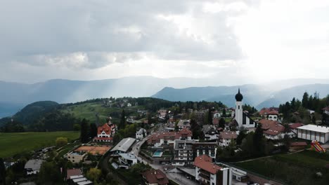 Drone-shot-of-a-mountainous-town-in-Italy's-countryside-on-a-beautiful-day