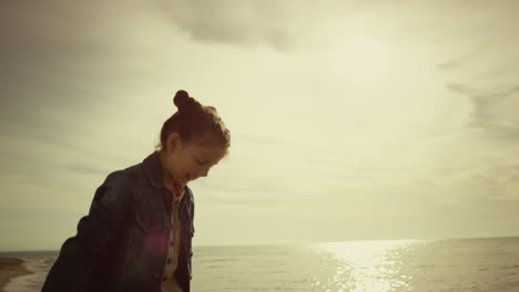 Happy-kid-playing-fun-at-sea-beach-coast.-Cute-girl-smiling-enjoy-family-holiday