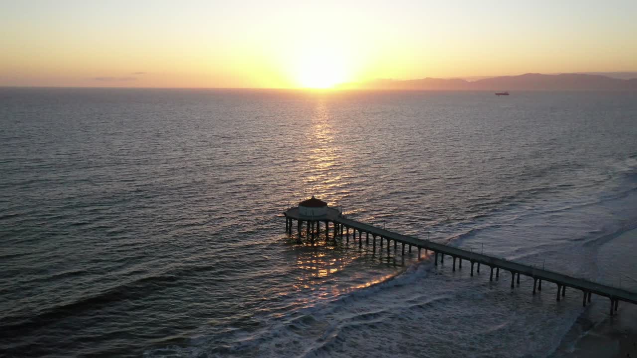 Beautiful Sunset Setting In The Horizon From Manhattan Beach With Pier And Roundhouse Aquarium. - aerial