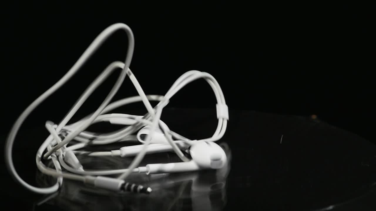 Jumping headphone On Moving Subwoofer on black background