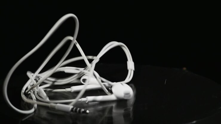 Jumping headphone On Moving Subwoofer on black background