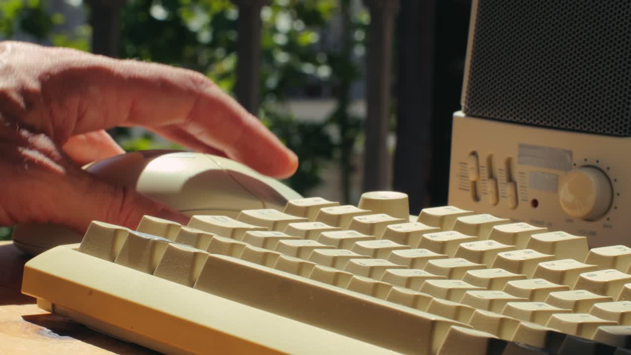 Man working and gaming on retro computer PC, IT engineer with vintage computer at home, using old fashion technology, close up of retro setup.