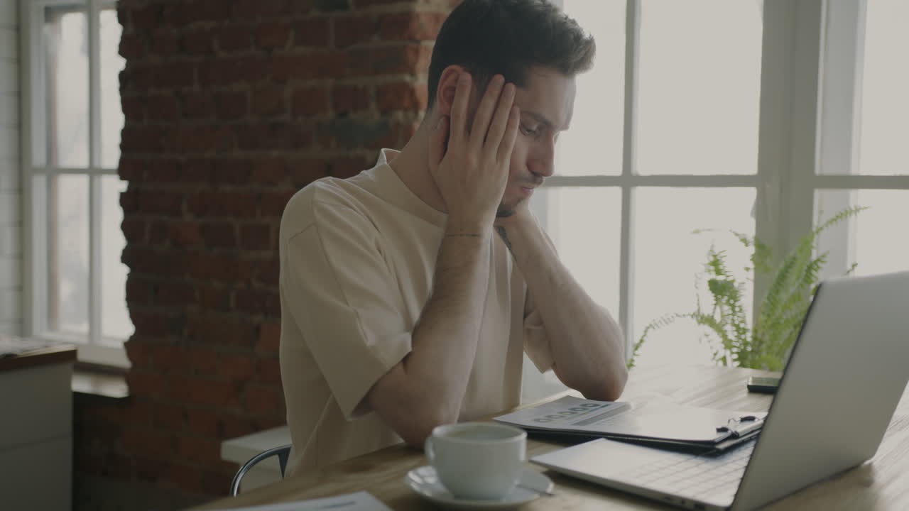Uomo che lavora al computer portatile a casa