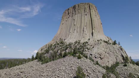 A-drone-shot-of-Devils-Tower,-a-massive,-monolithic,-volcanic-stout-tower,-or-butte,-located-in-the-Black-Hills-region-of-Wyoming