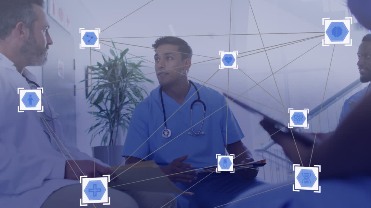 Animation of network of media icons over diverse group of doctors discussing in meeting