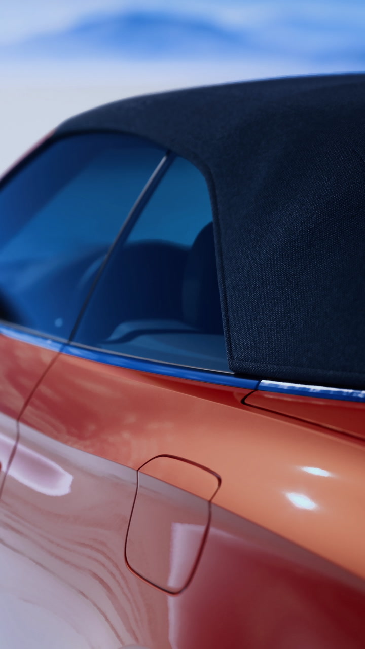Convertible car parked on a dry salt flat under clear blue skies