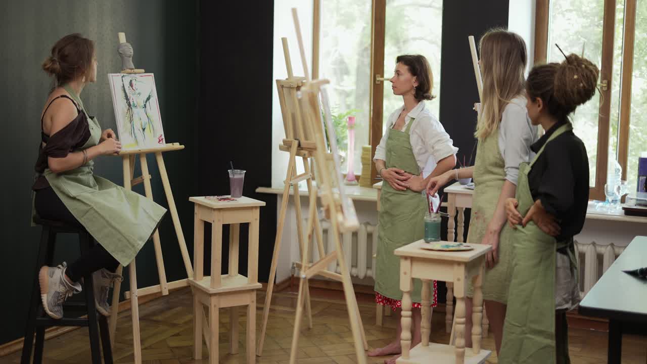 Female students at art workout leading by mentor