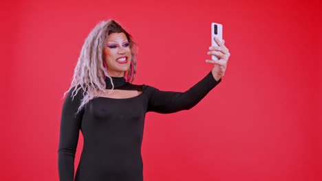 drag queen taking expressive selfies with smartphone