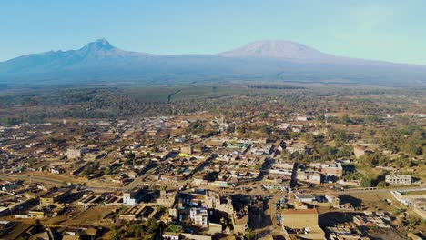 sunrise- kenya landscape with a village, kilimanjaro and amboseli national park - tracking, drone aerial view