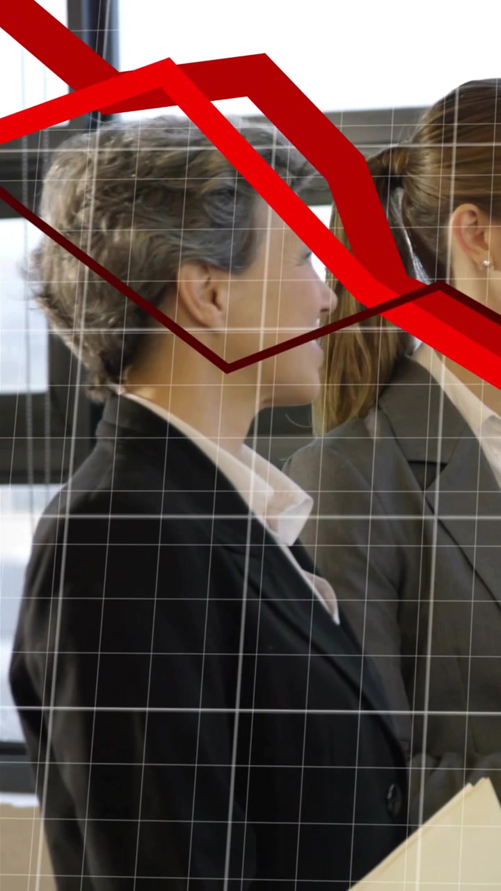 Video verticale: Zoom indietro che rivela due donne con cartelle, con un grafico rosso sui volti che mostra un calo del mercato.