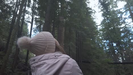 girl in forest looking up