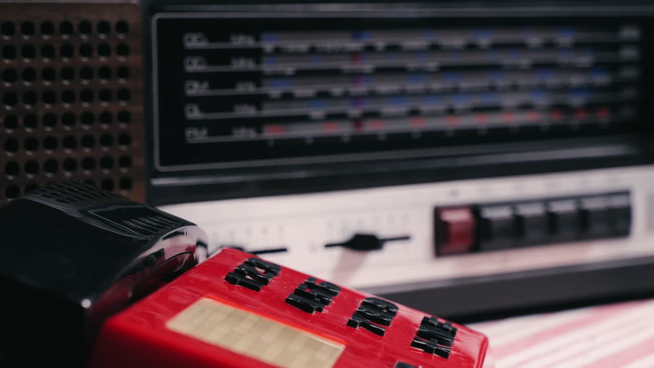 Retro vintage red phone, telephone is displayed on a wooden desk, adding a nostalgic touch. Man answer for call on button 90 phone.