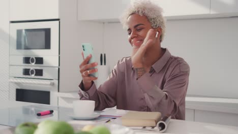Young african american woman answer video call on phone smile wave hand hello
