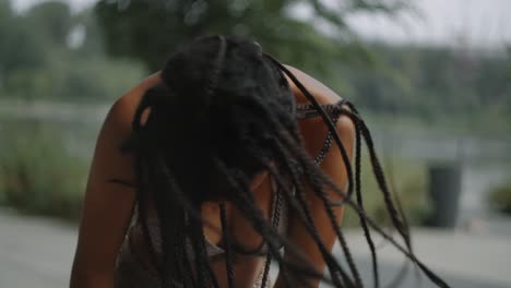 woman with braids in a park