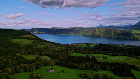 scenic attersee village in the lush forested landscape next to the lake, austria