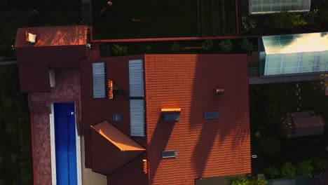 toma aérea de arriba hacia abajo de una hermosa casa con piscina y paneles solares