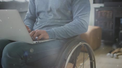 animation of light spots over disabled caucasian man in wheelchair using laptop