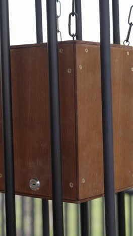 wooden box in a metal cage