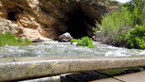 rushing water is seen flowing over a bridge