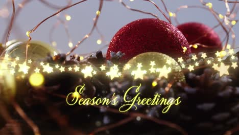 animation of seasons greetings text over christmas tree decorations